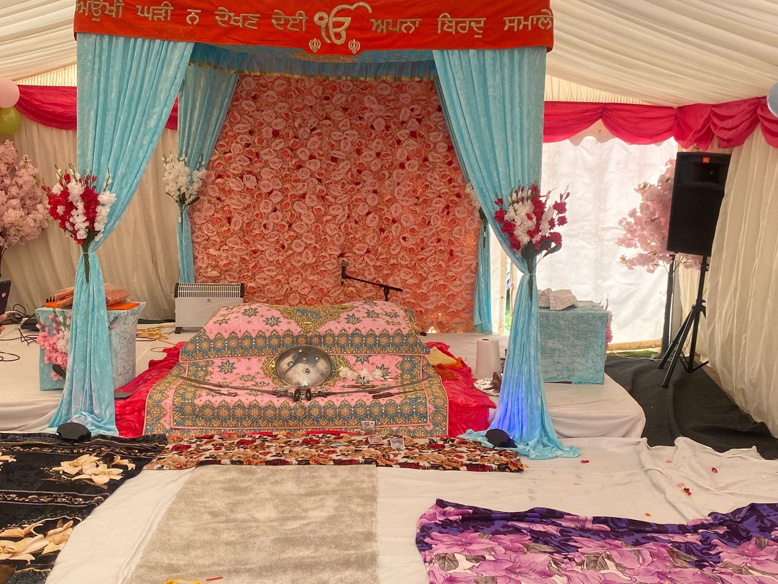 Anand Karaj stage decorated with flowers and drapery