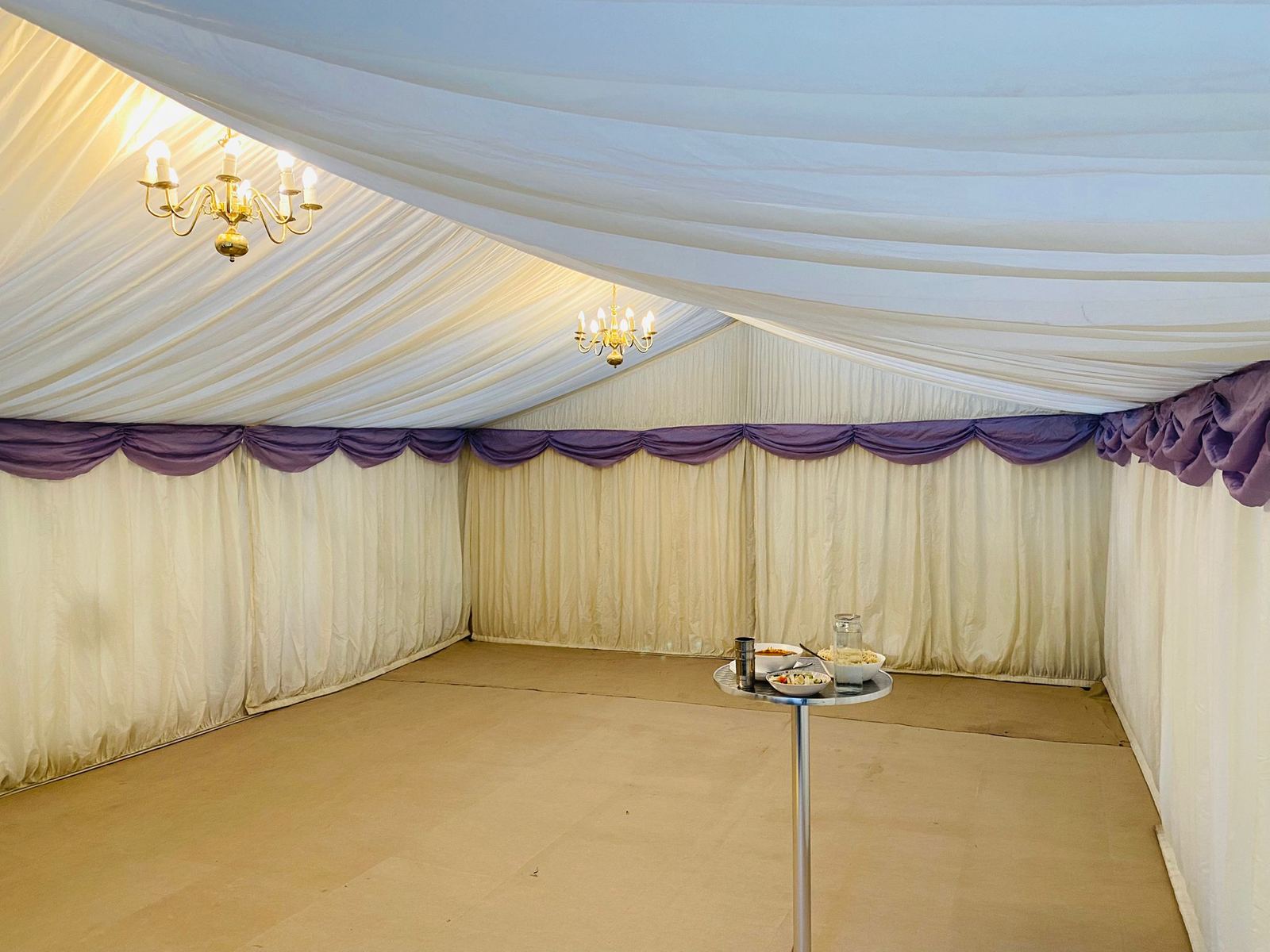 Empty marquee styled with lavender drapery