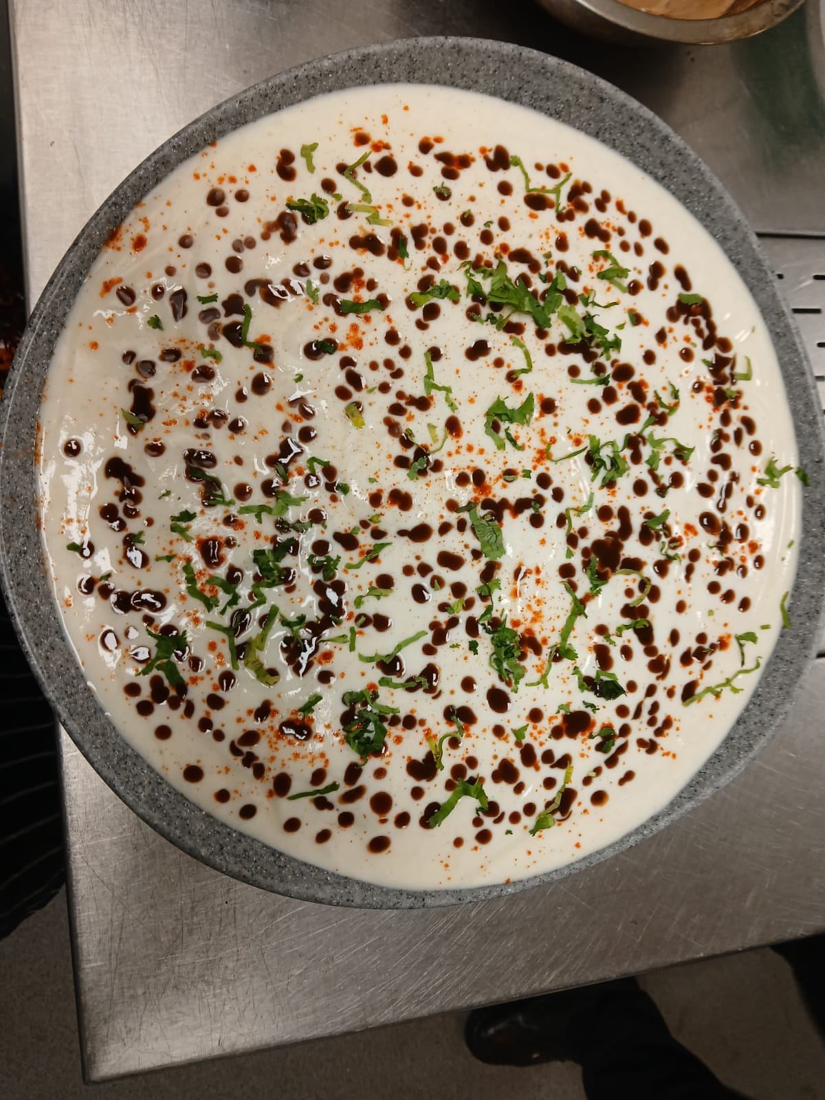 Raita finished with tamarind chutney and coriander