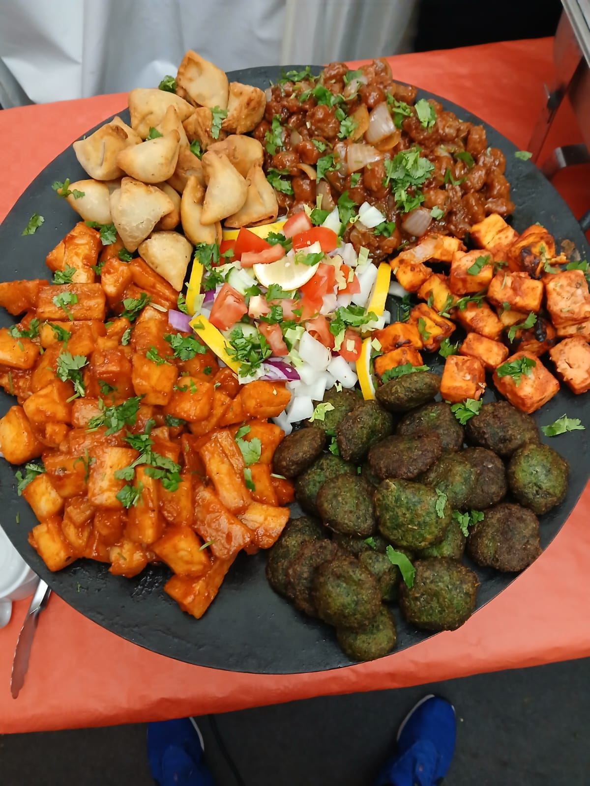 Mixed starters platter of paneer tikka, samosas and pakoras